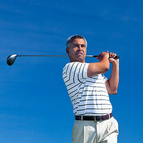 A man playing golf outdoors