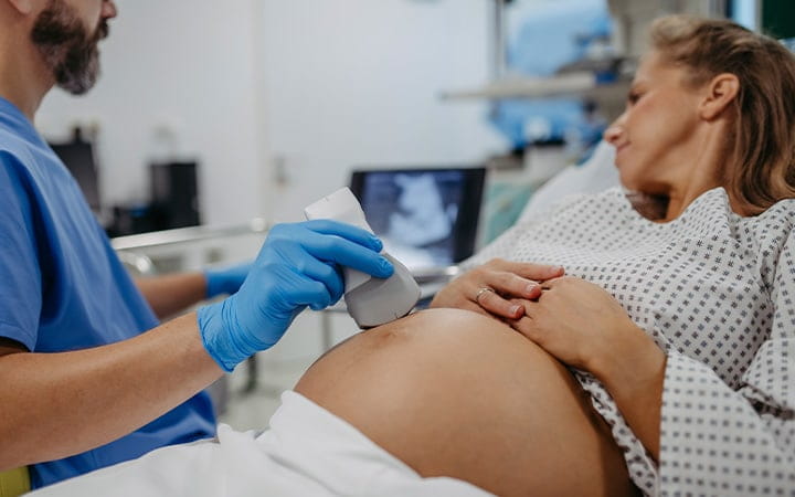 Pregnant woman getting ultrasound