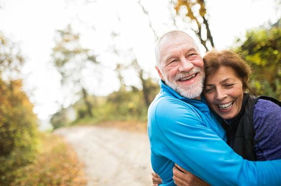 fit older couple hugging