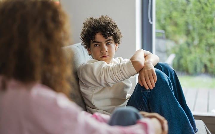 Teen sitting on couch