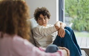 Teen sitting on couch