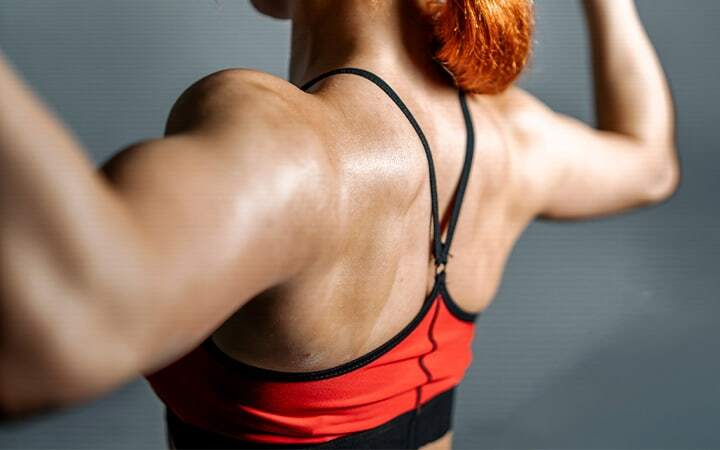 Woman flexing her shoulders and arms