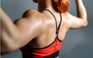 Woman flexing her shoulders and arms