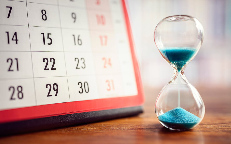 Hourglass and calendar depicting time slipping away