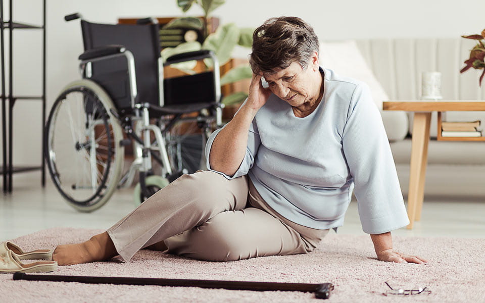 Senior woman with headache fell to the floor and looking for cane