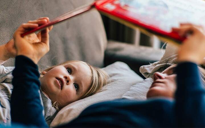 Mom reads book to child