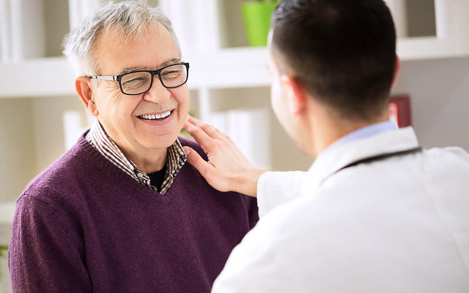 Smiling happy older patient visiting doctor