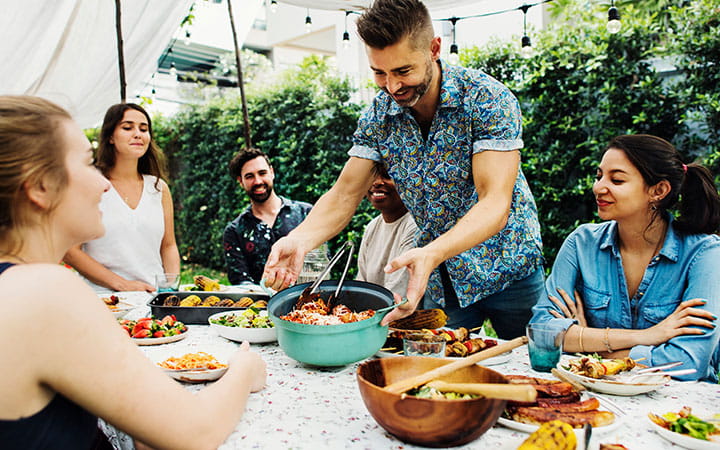 Family and friends enjoying meal outdoors