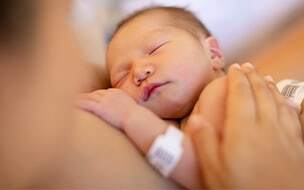 Newborn sleeps on mother's chest