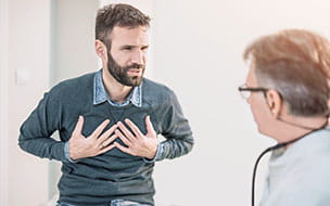 man clutching chest