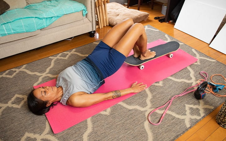 Woman exercising on floor at home