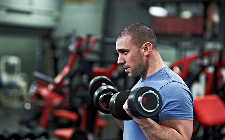 man holding dumbbells