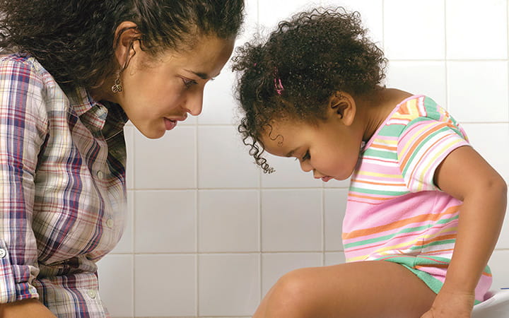 mom and daughter looking into baby potty
