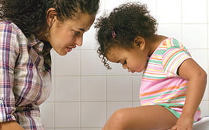 mom and daughter looking into baby potty