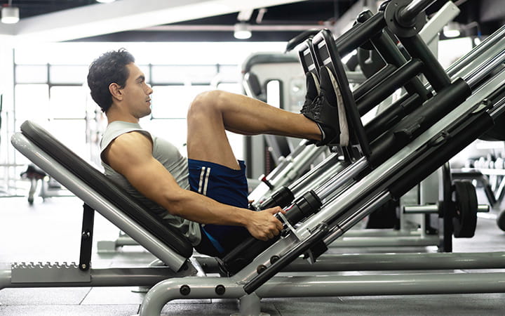 man using leg press machine