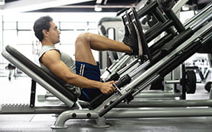man using leg press machine