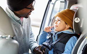 Smiling infant in a car seat