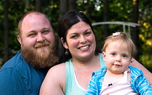 A smiling Abby and her family