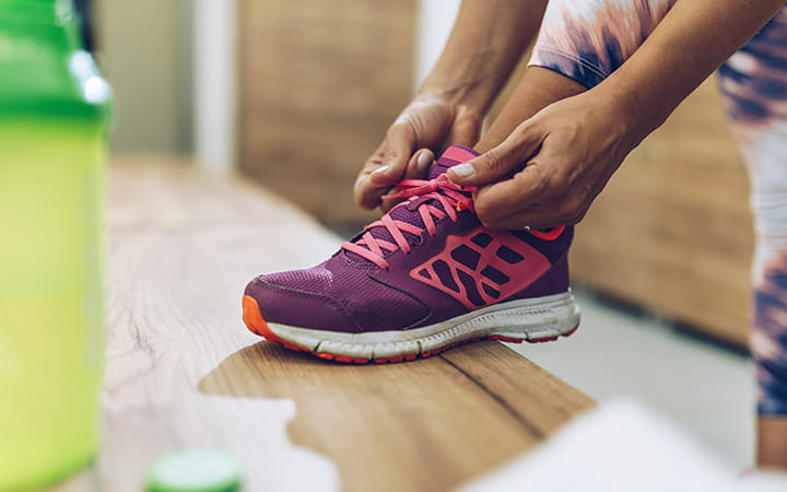 Hands tying running shoes