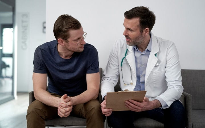 A mature doctor discussing a vasectomy with a male patient