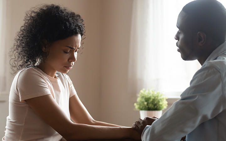 Woman consoled by doctor