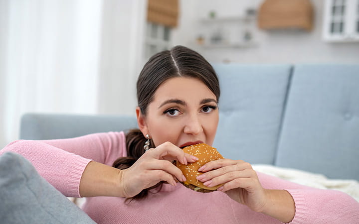 woman eating a hamburger