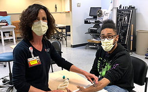 Howard Stone in therapy with Patrice Volkens, OTR at at University Hospitals Twinsburg Health Center