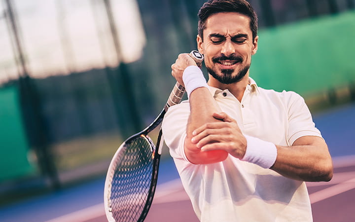 tennis player clutching elbow