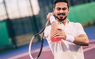 tennis player clutching elbow