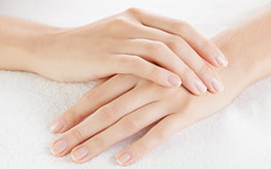 woman's hands resting one atop the other