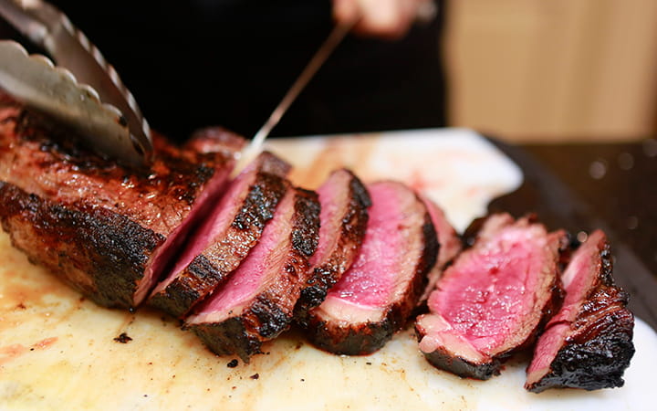slicing a rare filet mignon