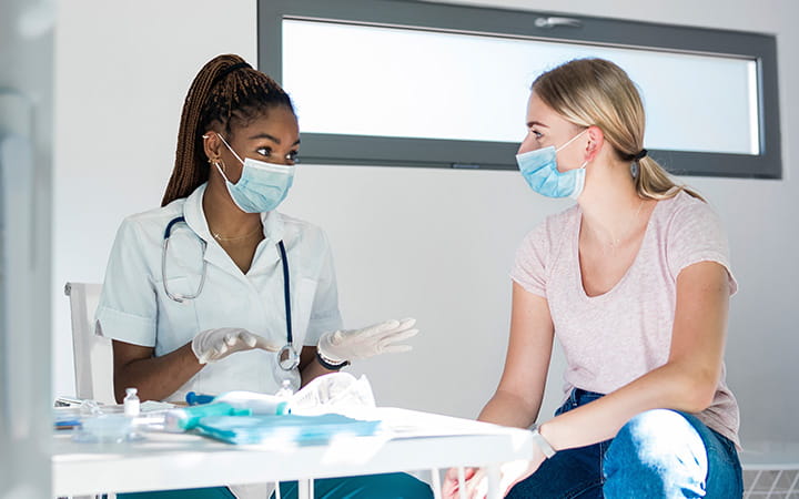 doctor meeting with woman at table