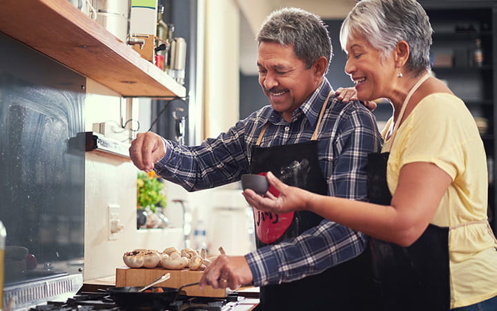older man and woman preparing food