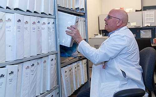 Paul McGuigan, BSN, RN, CDCES refiles a binder