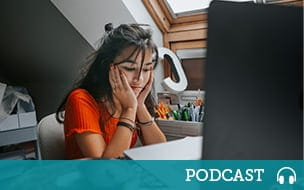 A female teenager feeling stressed studing at home