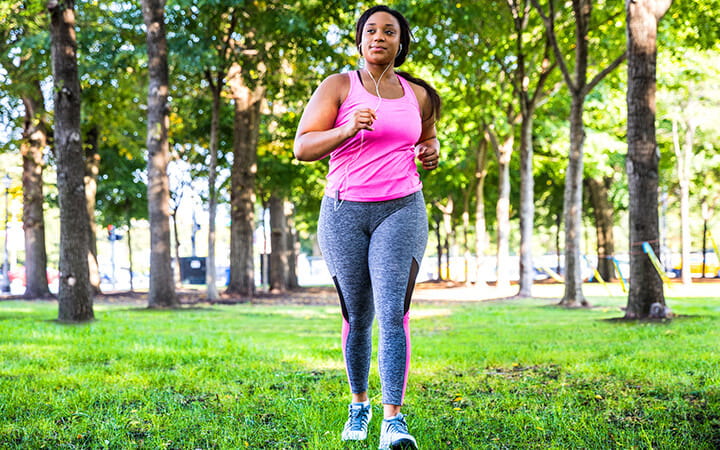 A woman jogging and exercising at the park