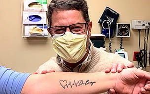 Kathleen Black proudly displays her tattoo