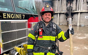 Firefighter and paramedic Ricky Fetter stands beside Engine 7