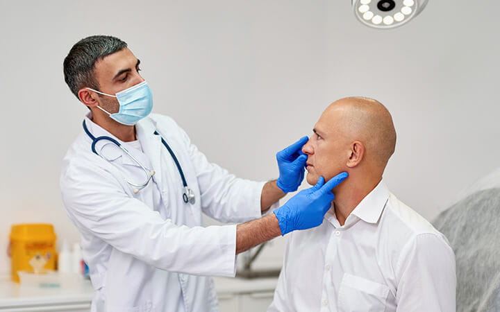 Man meeting with plastic surgeon before operation in clinic
