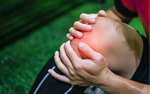 Male soccer player suffering from knee injury on field