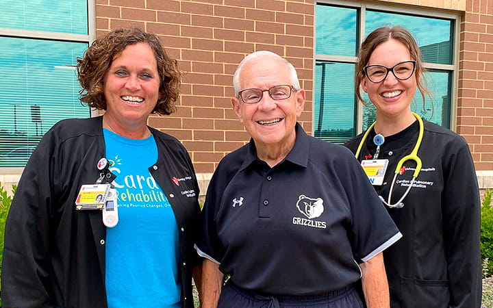 Father Fred stands outside UH Lake Brunner Sanden Deitrick Wellness Center