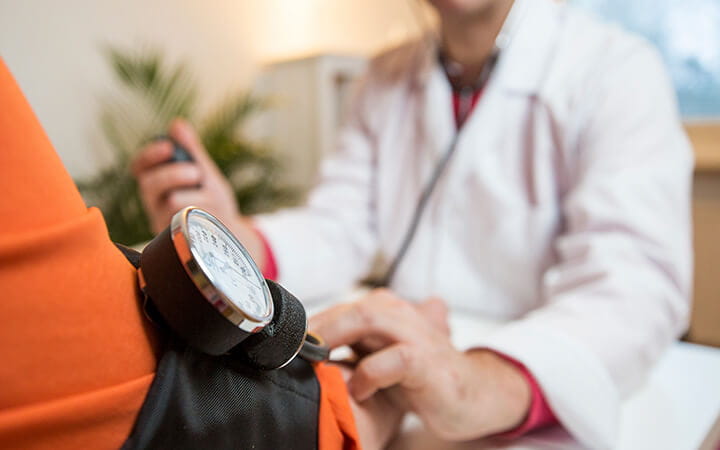 Woman having blood pressure checked