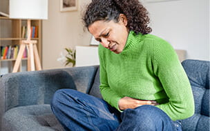 woman in pain holding stomach