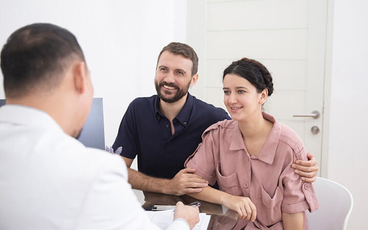 Man and woman meeting with doctor