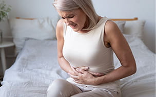 woman in pain holding stomach