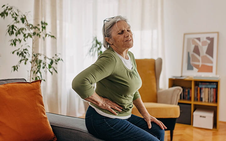 Woman in pain clutching her side