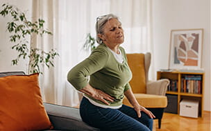 Woman in pain clutching her side