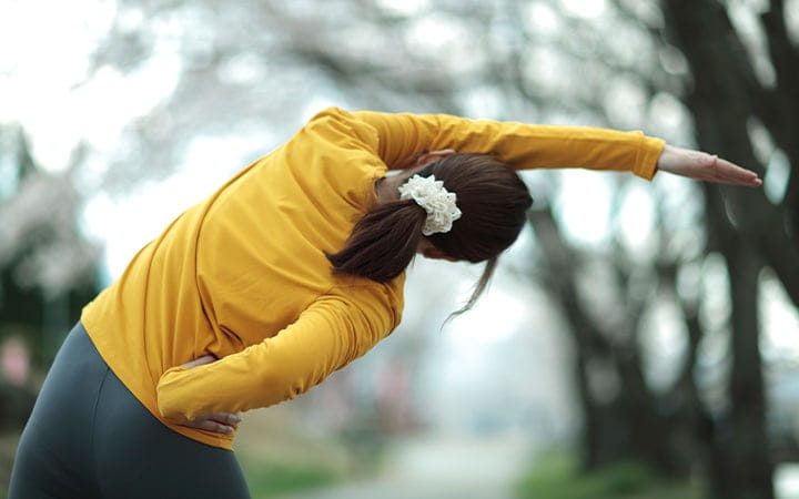A woman stretching outdoors