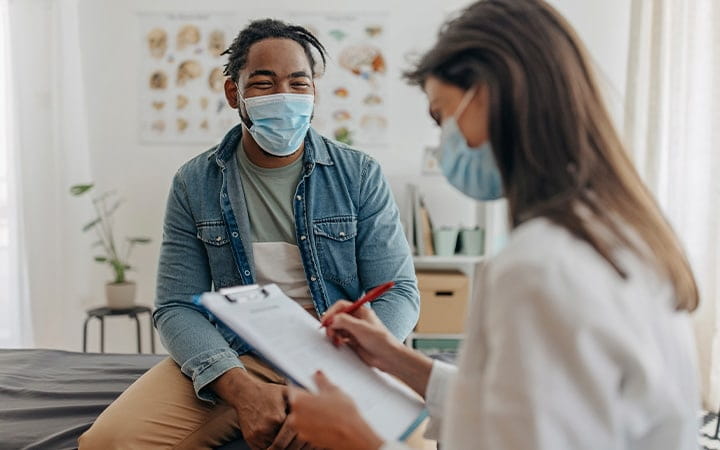 Young man talking with a doctor
