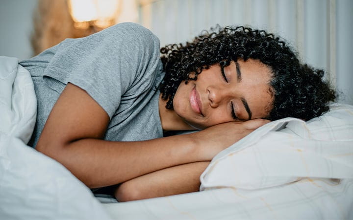 A young woman sleeping in bed